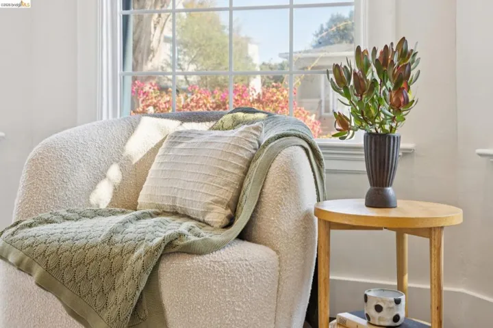 White interior walls with a large window featuring mullions
