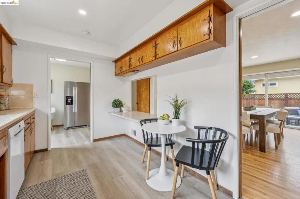 Wood-finish flooring throughout, with a pass-through counter and built-in wood cabinetry