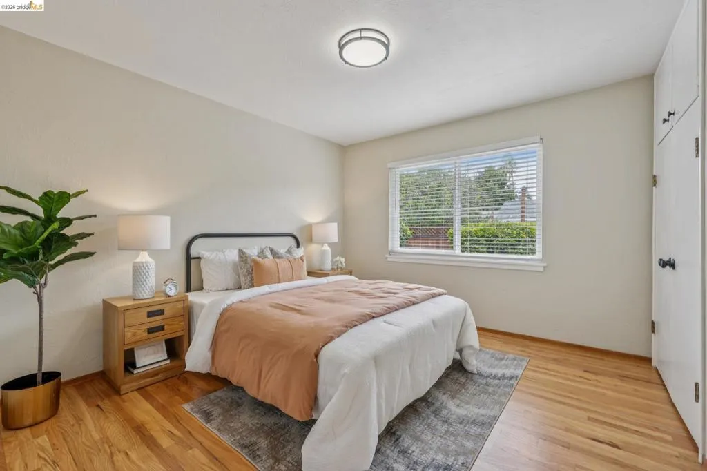 Hardwood flooring, recessed lighting, built-in storage, window with blinds, and neutral wall tones