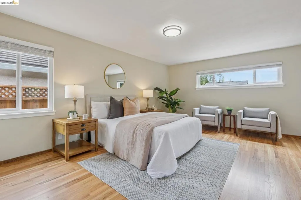 Hardwood flooring, multiple windows, recessed lighting, and light neutral wall colors