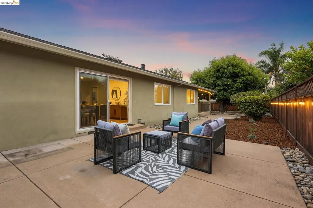 Expansive concrete patio with direct access to the interior via a sliding glass door