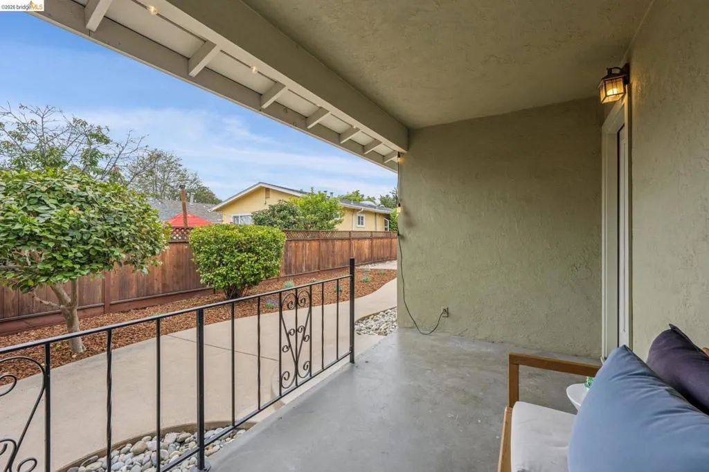 Covered patio featuring concrete flooring and a stucco wall