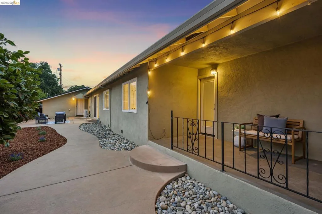Covered front porch with decorative iron railing