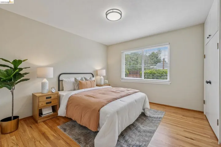 Hardwood flooring, recessed lighting, built-in storage, window with blinds, and neutral wall tones