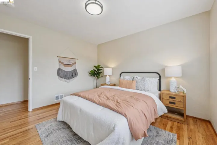 Hardwood flooring, light-colored wall paint, white trim, and a ceiling-mounted light fixture