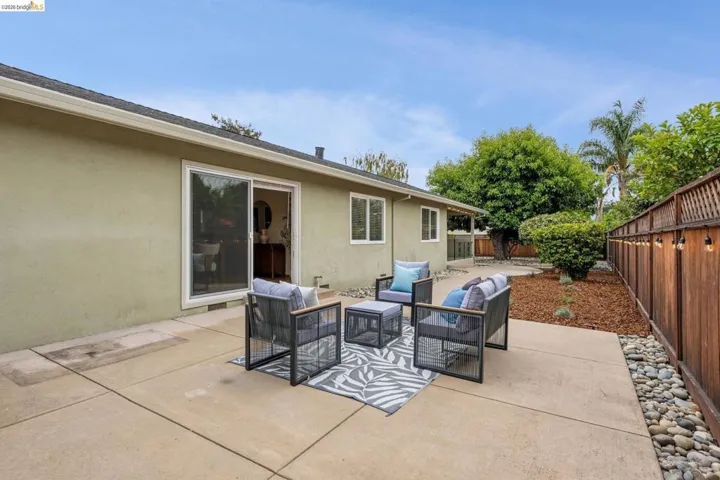 Expansive concrete patio with sliding glass door access