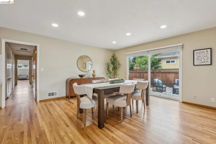 Recessed lighting, wood-finish flooring, sliding glass door, private patio, and wooden fence