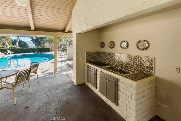 Covered Clubhouse area by the pool for gatherings.