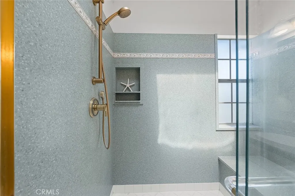 Huge step-in shower with large built-in bench, great for company or even bathing the dog.