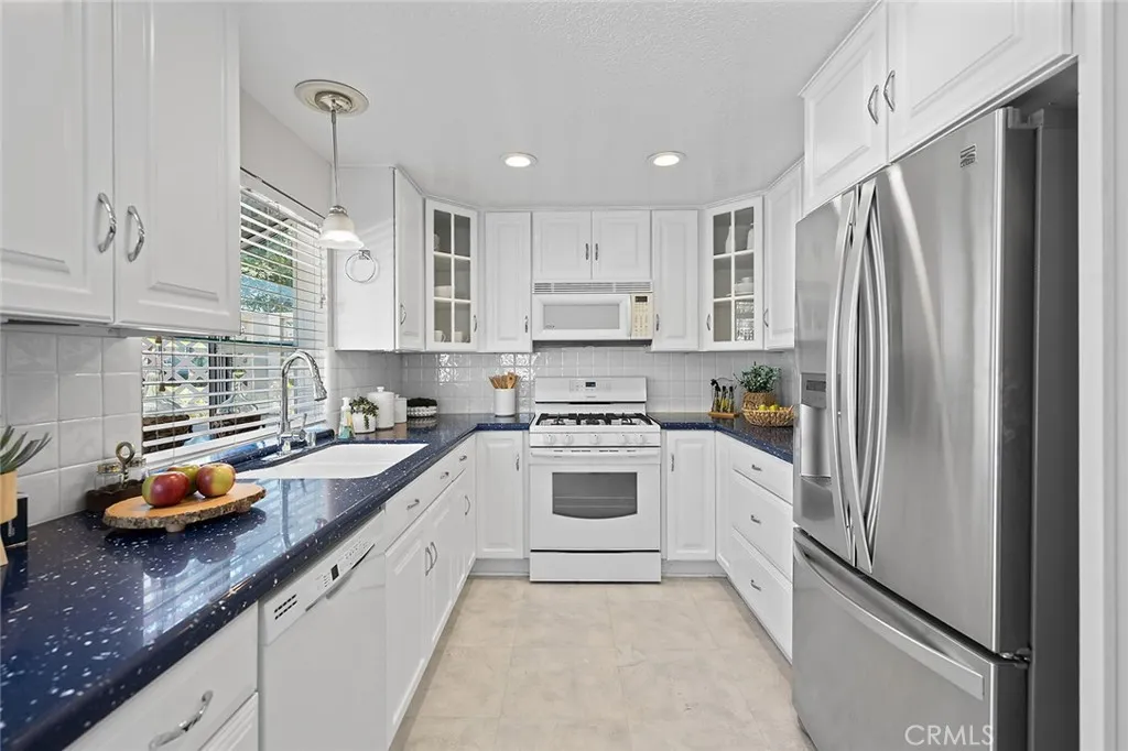 The kitchen has so much storage and beachy blue counter tops