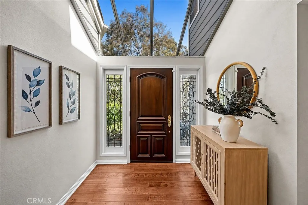 Formal entryway with an extravagant glass roof which floods the space with natural light.