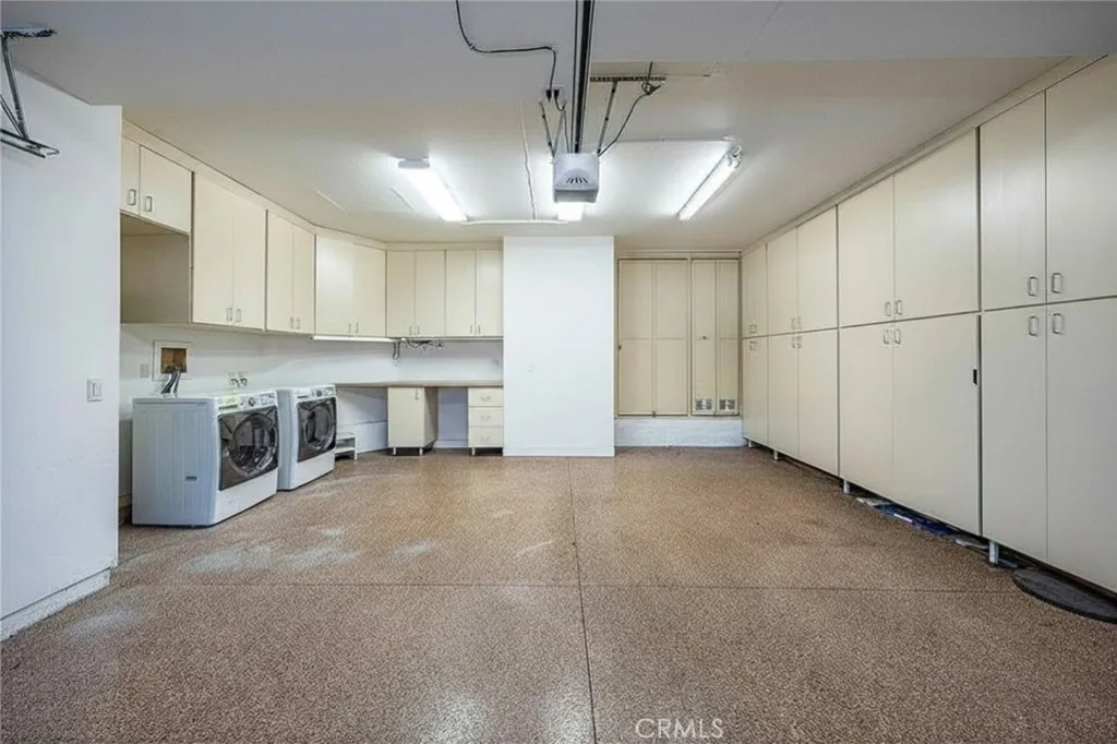 Fully finished garage with lots of built-in storage and epoxy floors