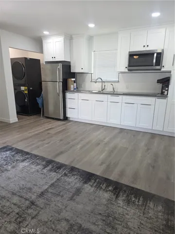 kitchen area and brand new washer and dryer in unit