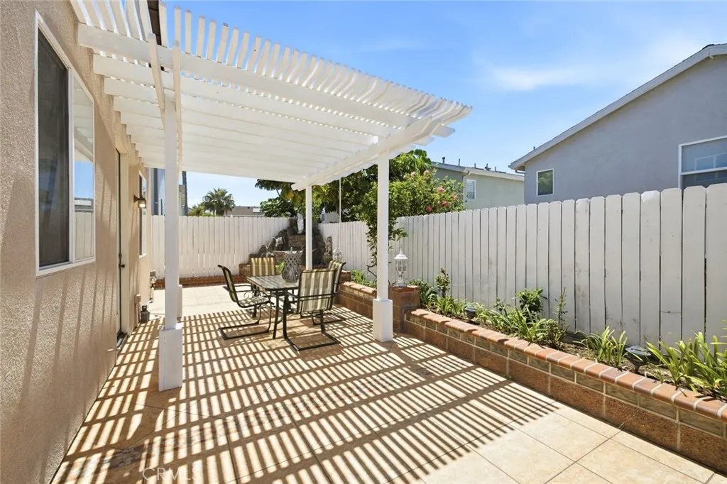 Enjoy the backyard, fully tiled with a pergola covered patio.