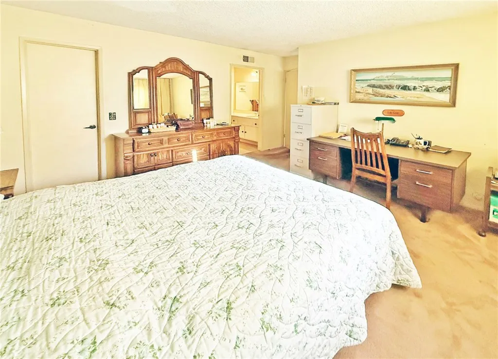 Primary Suite with Walk-In Closet and Ensuite Bathroom with Shower, Tile Flooring, and a Sit-Down Vanity