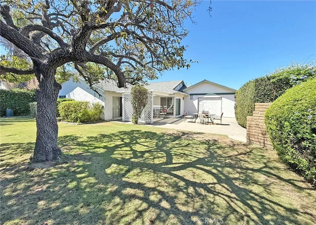 Gorgeous Warp-Around Backyard with Manicured Landscaping, Mature Shade Tree, Lattice-Covered Patio, Big Open Patio with a Boat-Door to the Garage, and a Built-In BBQ. Auto Sprinkler System Front and Rear