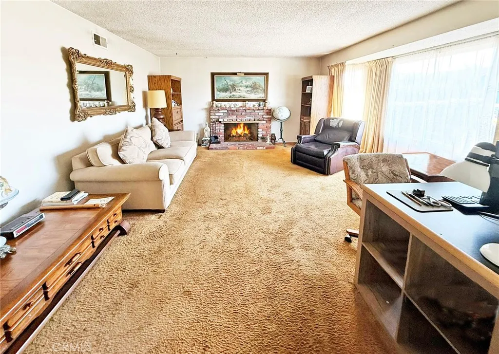 Extra Large Formal Living Room with Brick Fireplace and Big Picture Window