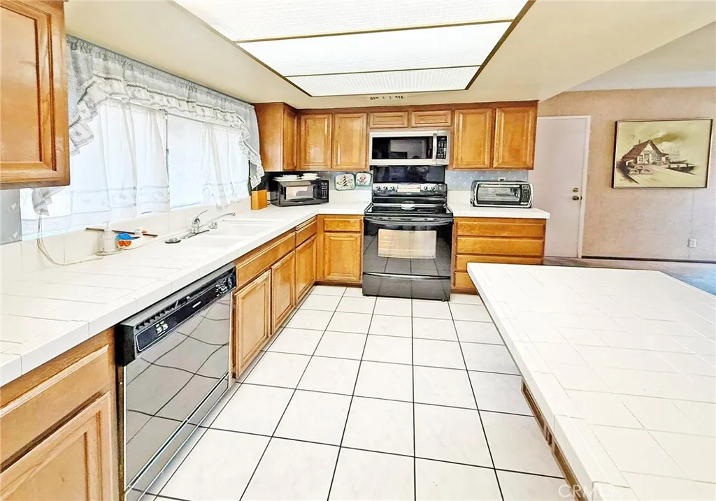 Bright Kitchen with Two-Sided Counter-Height Breakfast Bar and Walk-in Pantry