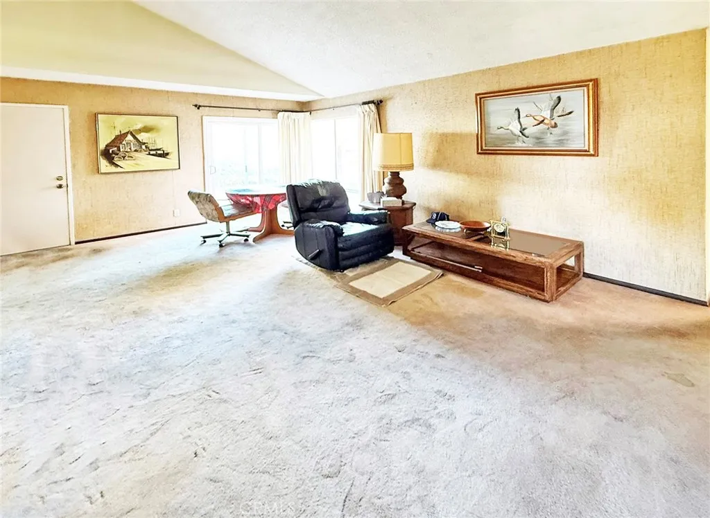 Family Room with Vaulted Ceiling, Dining Area, and Sliders to the Backyard