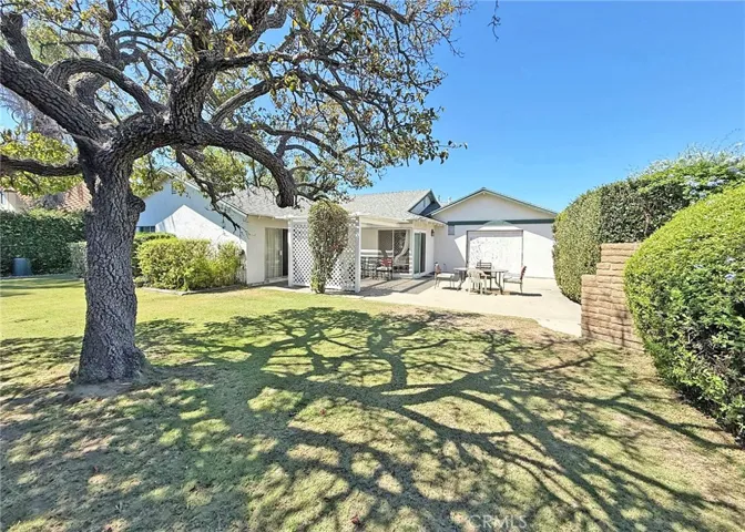 Gorgeous Warp-Around Backyard with Manicured Landscaping, Mature Shade Tree, Lattice-Covered Patio, Big Open Patio with a Boat-Door to the Garage, and a Built-In BBQ. Auto Sprinkler System Front and Rear