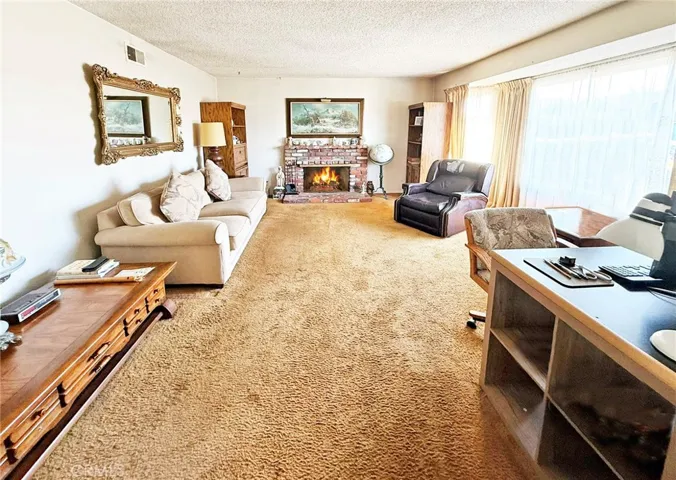 Extra Large Formal Living Room with Brick Fireplace and Big Picture Window