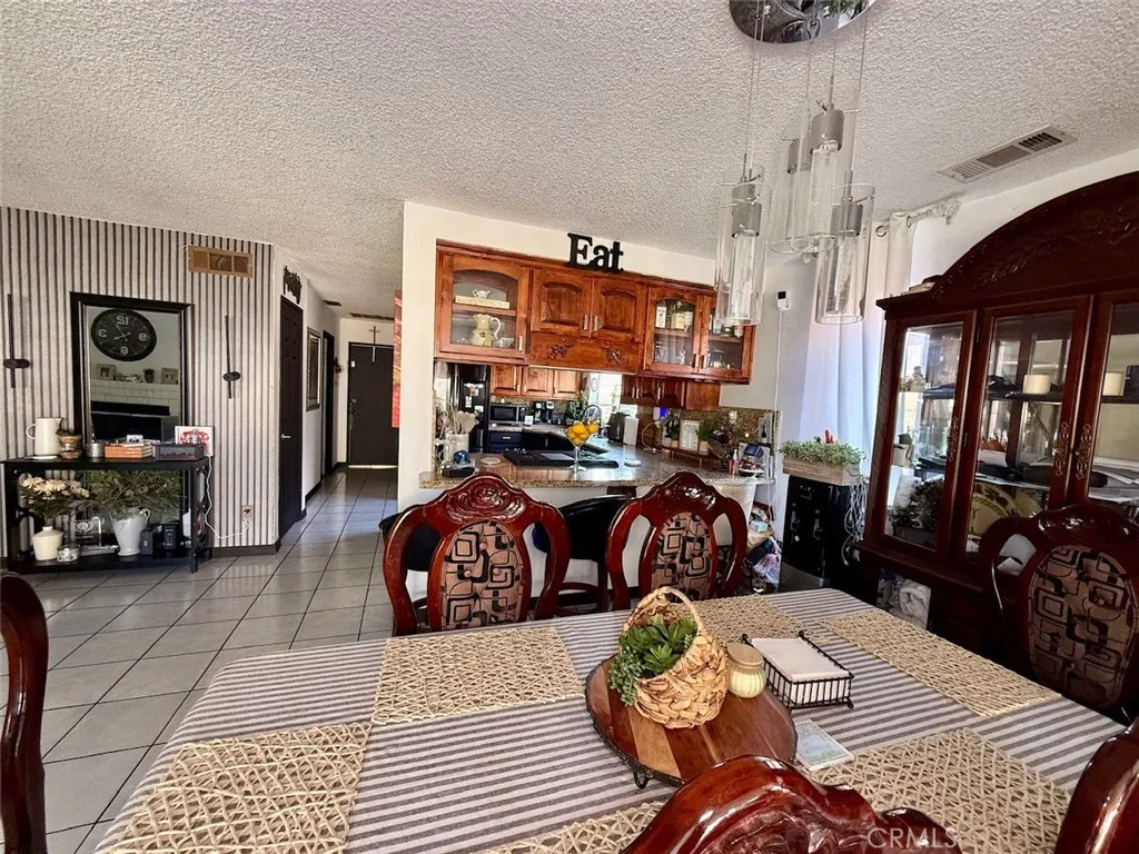 Dining room into kitchen. Hallway leading to downstairs bedroom and bathroom. Also entry to garage.