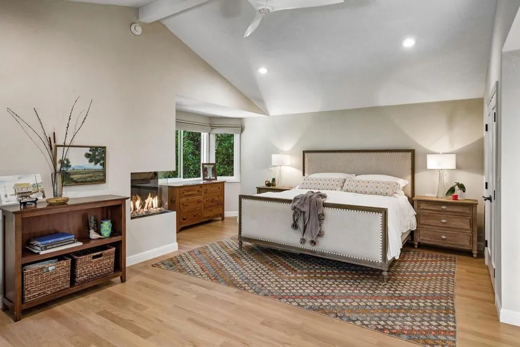 Primary with vaulted ceilings, corner gas fireplace