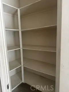 Generous pantry with extensive built-in shelving for additional storage.