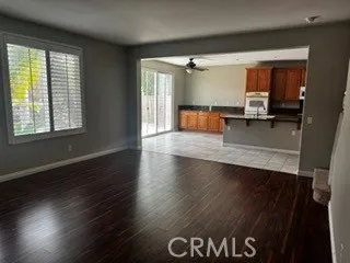 Living Area – Spacious open living area with wood-style flooring and direct connection to the kitchen.