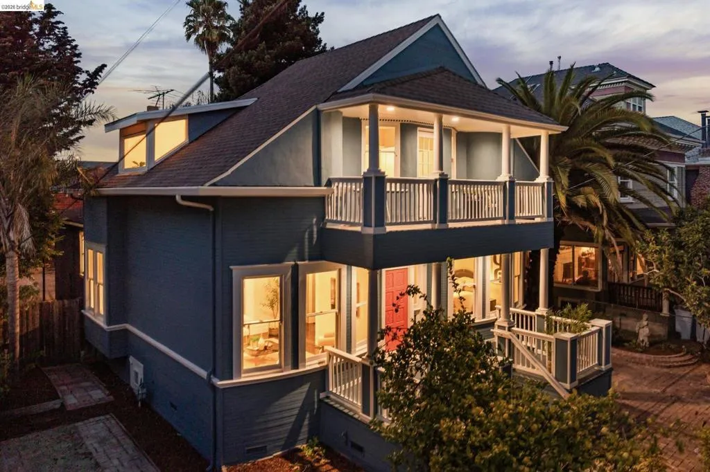 Multi-level exterior with a balcony, covered porch, dormer window, and bay windows