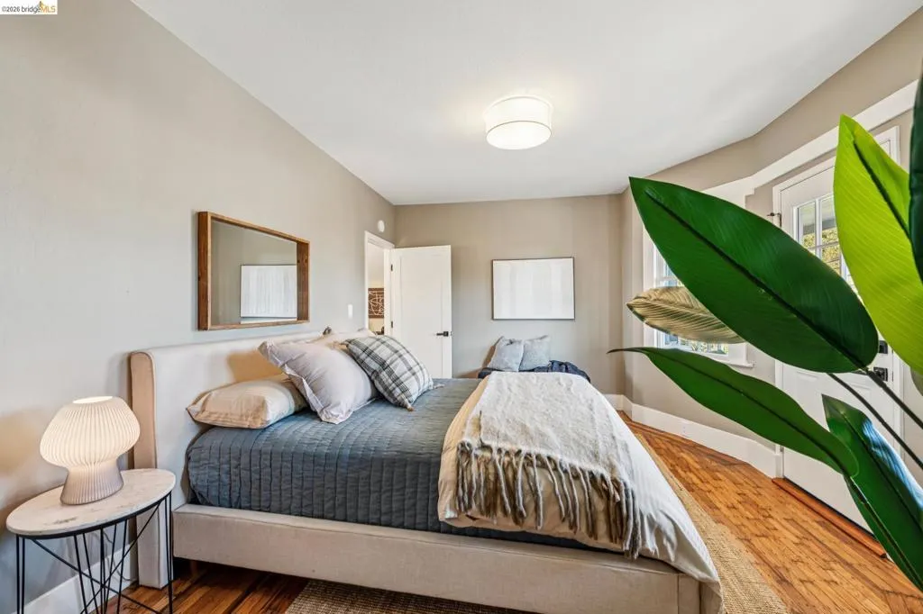 Hardwood-finish flooring, recessed ceiling light, transom window, bay window, and a door with glass panels