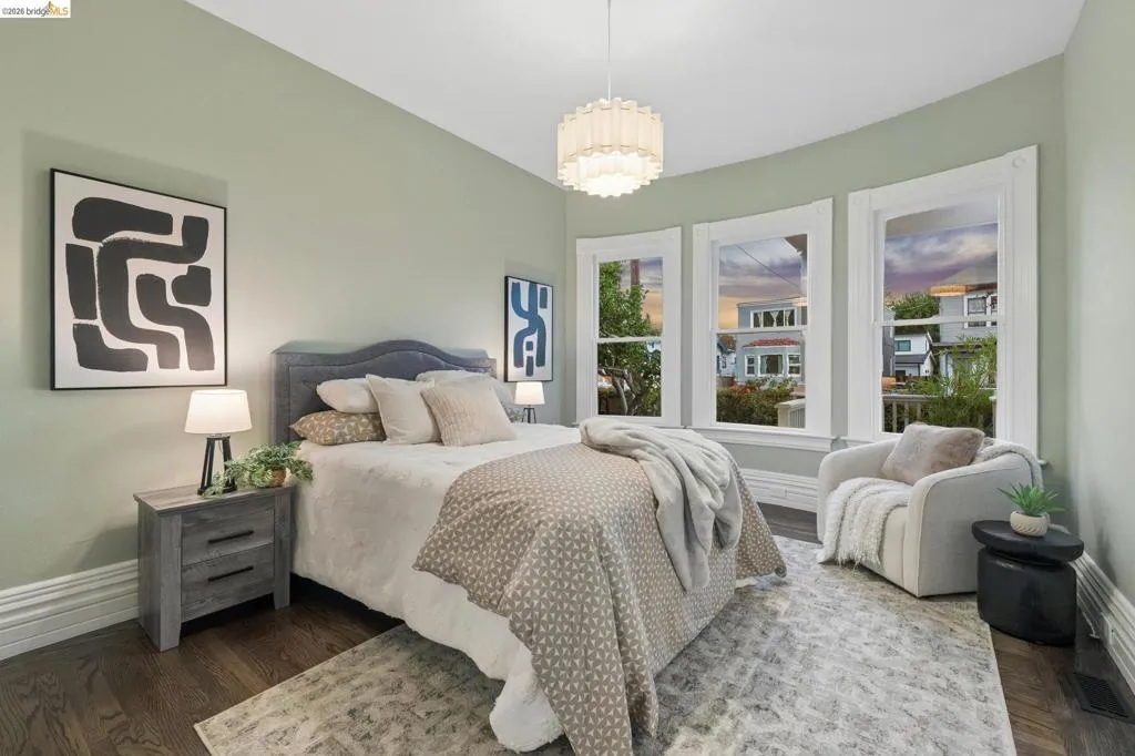 Recessed lighting and a decorative chandelier illuminate the space