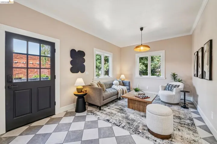 Entry with multi-pane door, checkered tile flooring, and crown molding