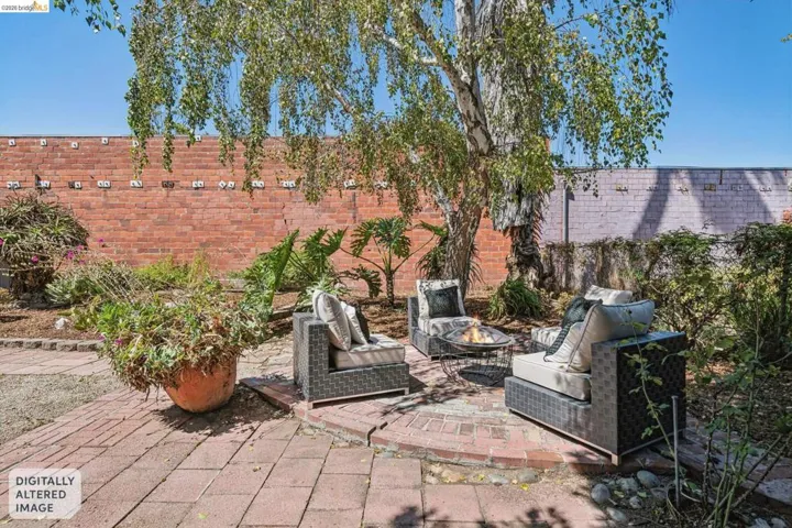 Brick paver patio featuring a central fire pit