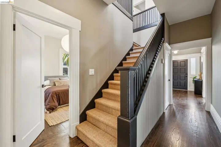 Dark wood-finish flooring extending through the hallway