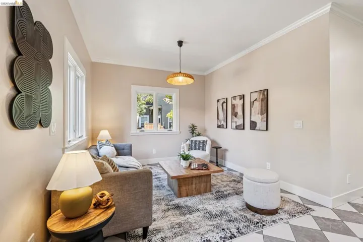 Recessed windows, crown molding, and a semi-flush mount fixture complement the light-toned walls