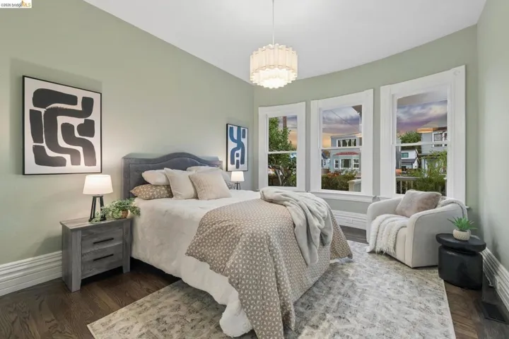Recessed lighting and a decorative chandelier illuminate the space