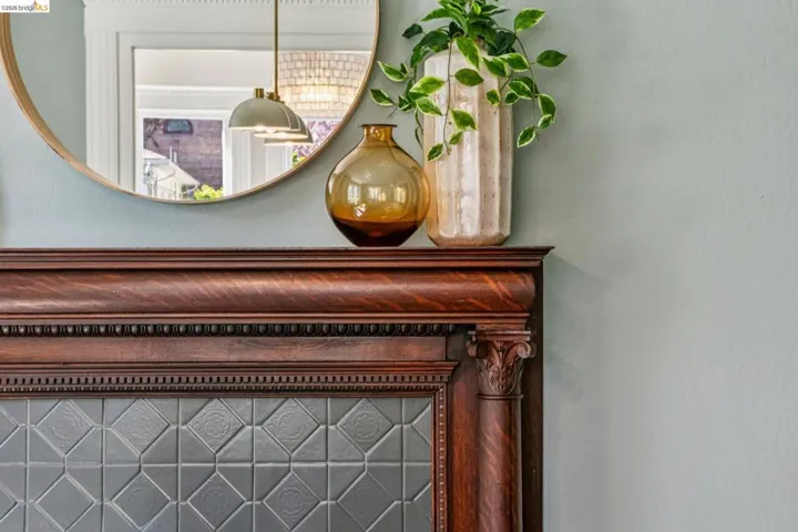 Ornate wood mantel featuring carved details and corbels