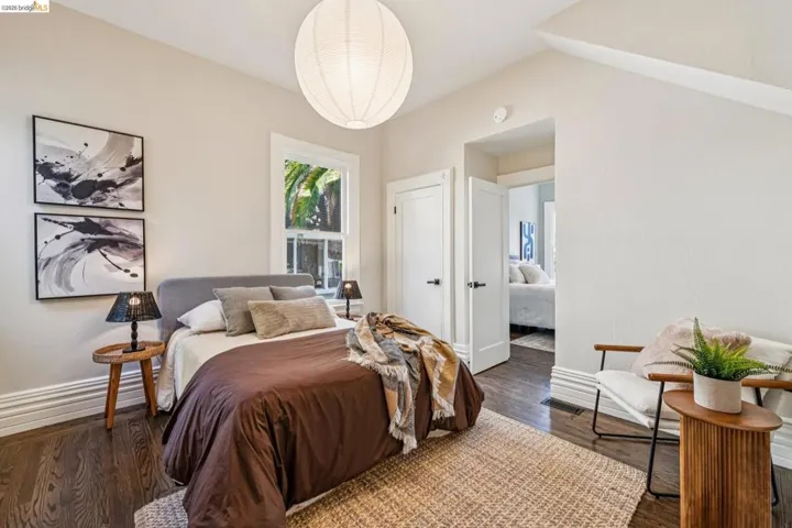 Hardwood flooring, white trim, recessed lighting, and a crisp white door with black hardware