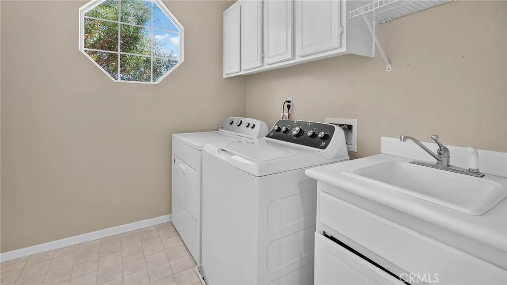Upstairs laundry room with sink