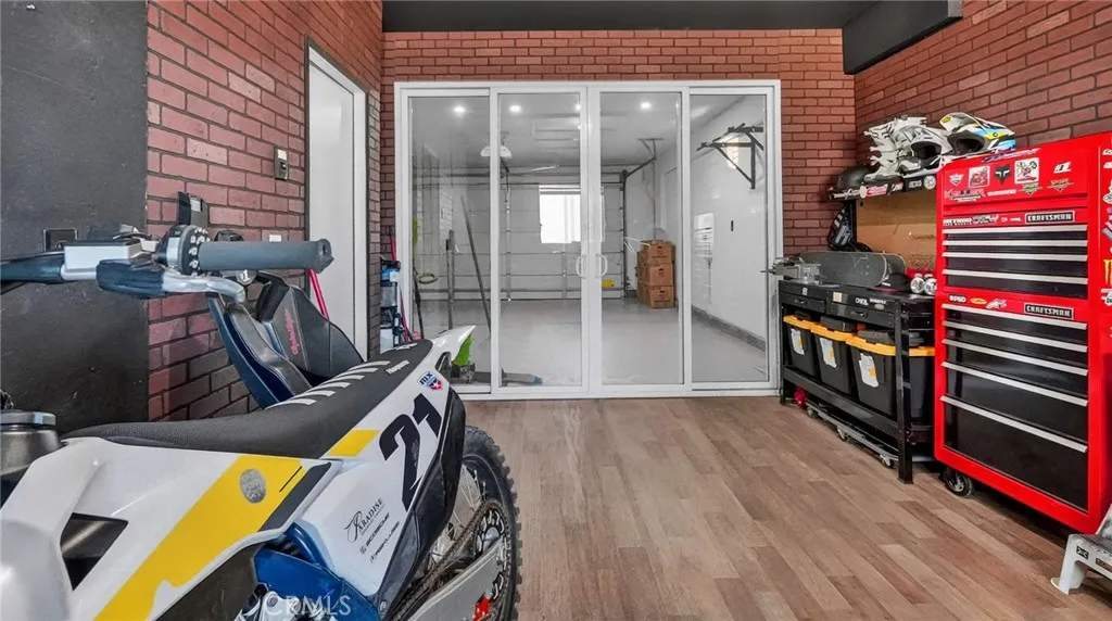 Built in sliding doors in third car bay leads to main garage