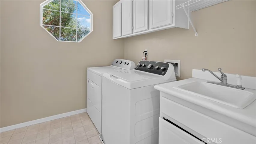 Upstairs laundry room with sink