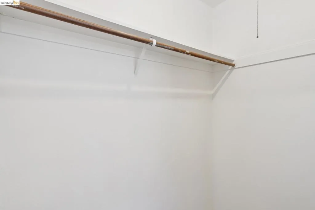 Bedroom – Walk-In Closet with Mirrored Doors Bedroom – Walk-In Closet with Mirrored Doors