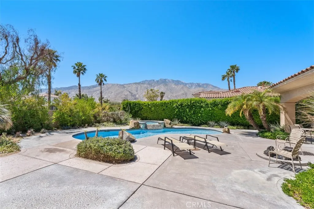 Beautiful pool and spa with water fall and views of the mountains