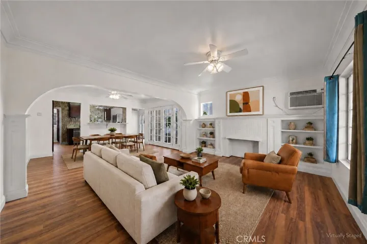 bright and spacious living room with fireplace and built ins