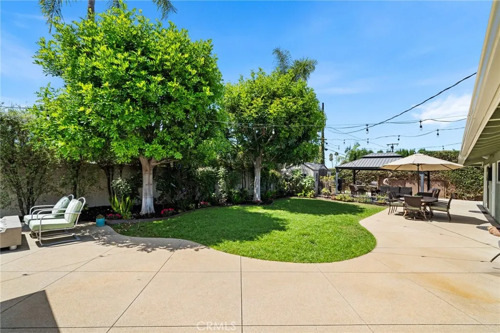 A backyard with both grass and patios
