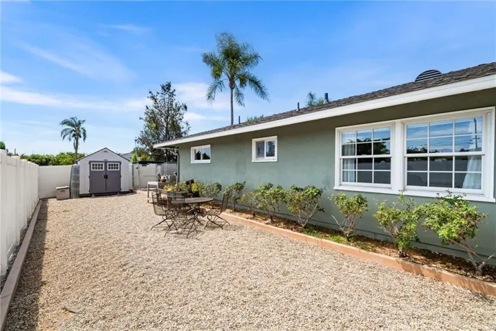 The side yard has two sheds that can stay with the property - this part of the yard sides to Sandhurst. Such a private corner lot!