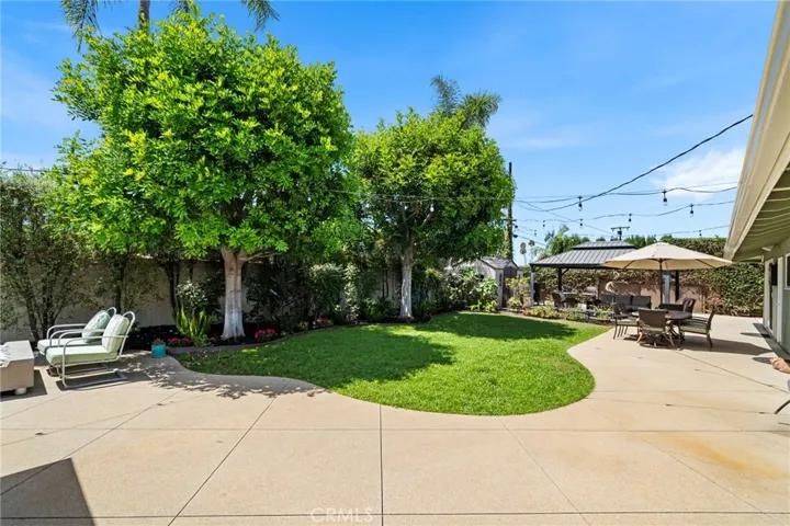 A backyard with both grass and patios