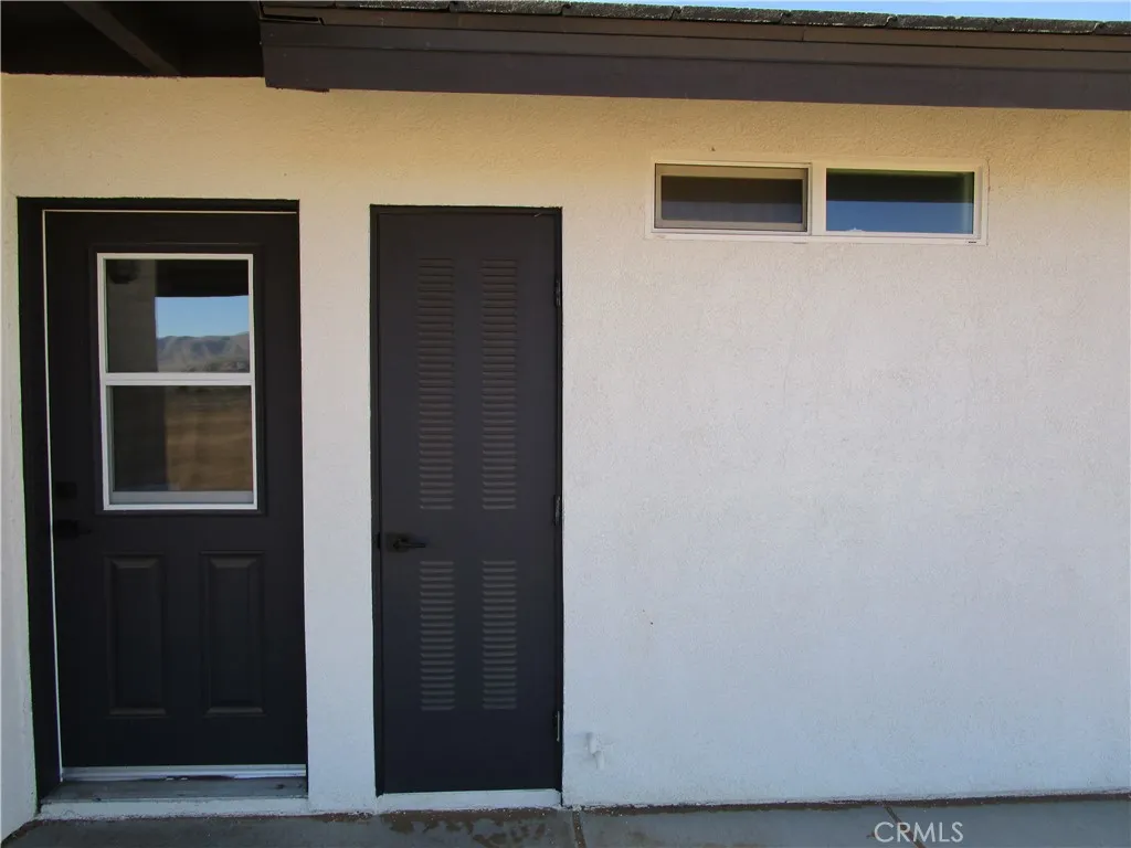 BACK DOOR TO LAUNDRY ROOM & WATER HEATER ACCESS.
