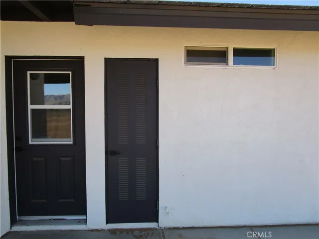 BACK DOOR TO LAUNDRY ROOM & WATER HEATER ACCESS.